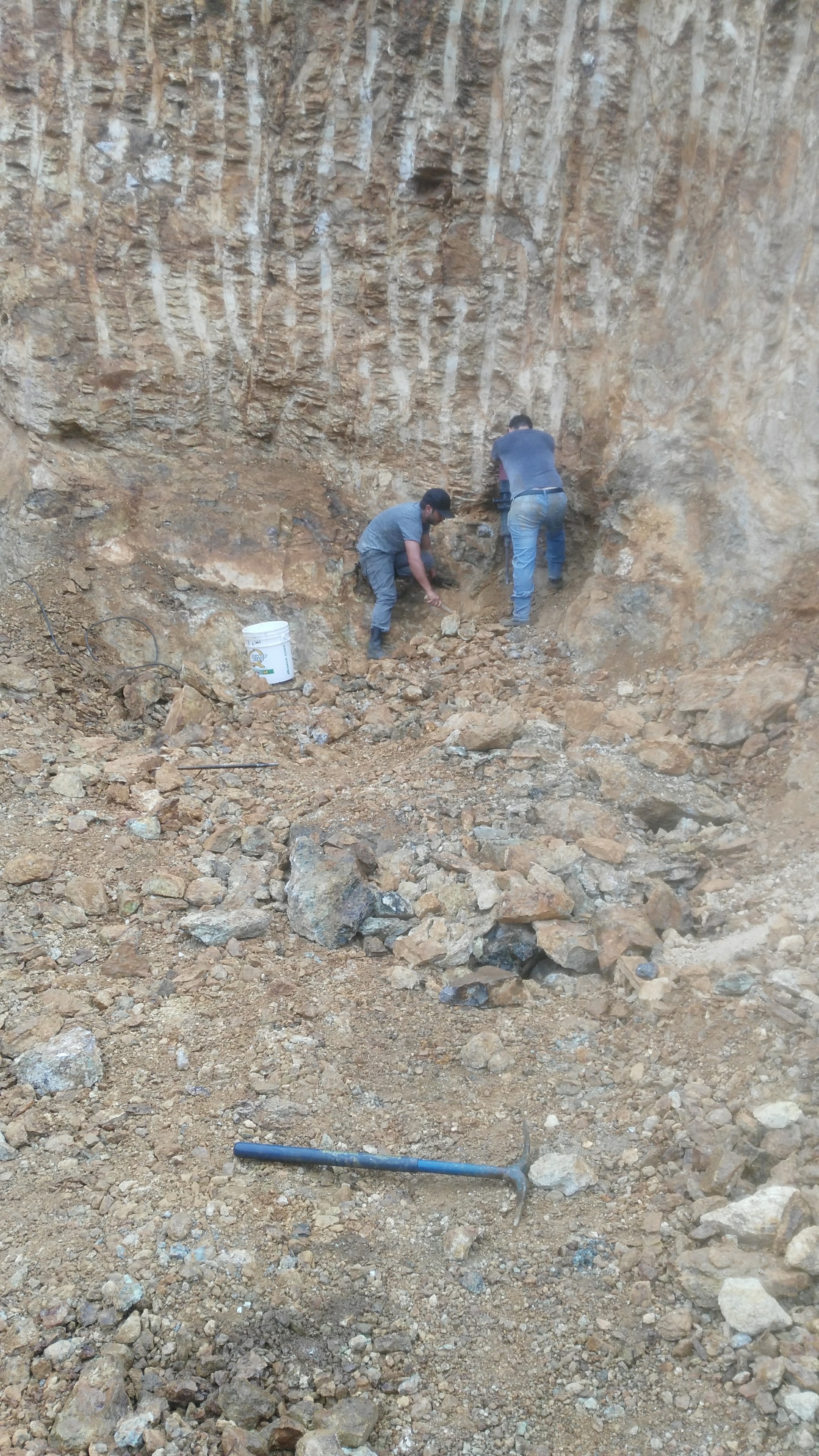 Workers excavating the rocky quarry site