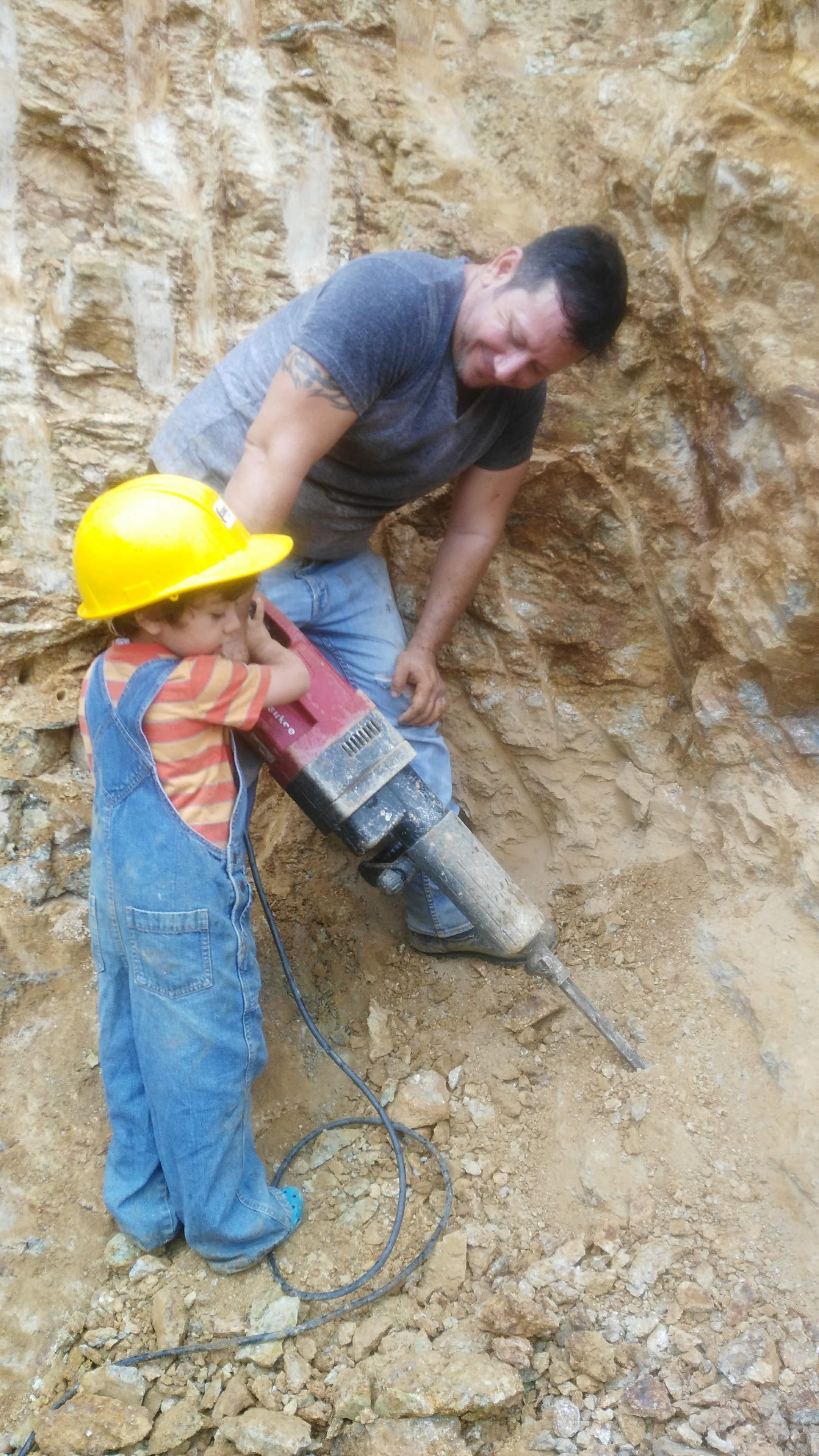 Father teaching child at the mine