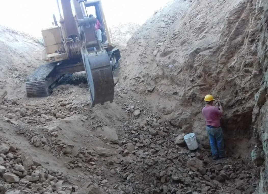 Excavator digging at the mine site