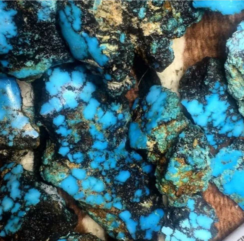 Vivid blue turquoise rough stones with black matrix